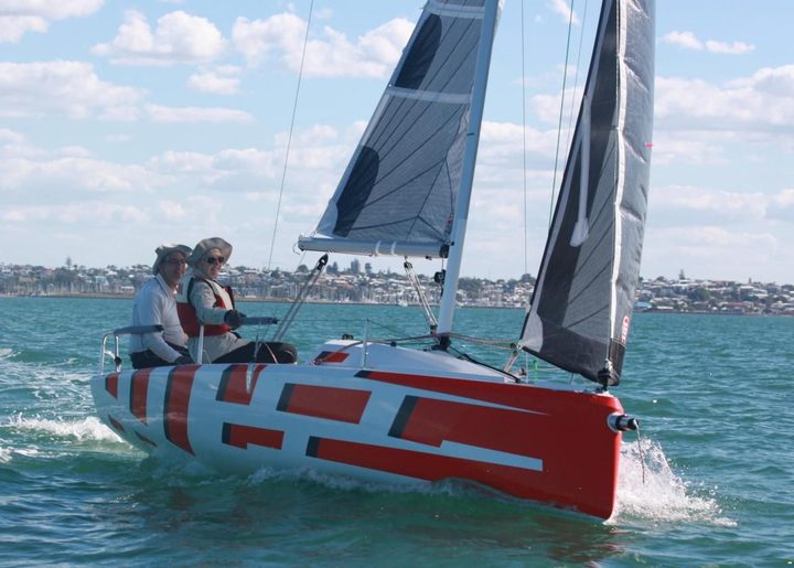 Red and white Fareast 19R sailing on open water