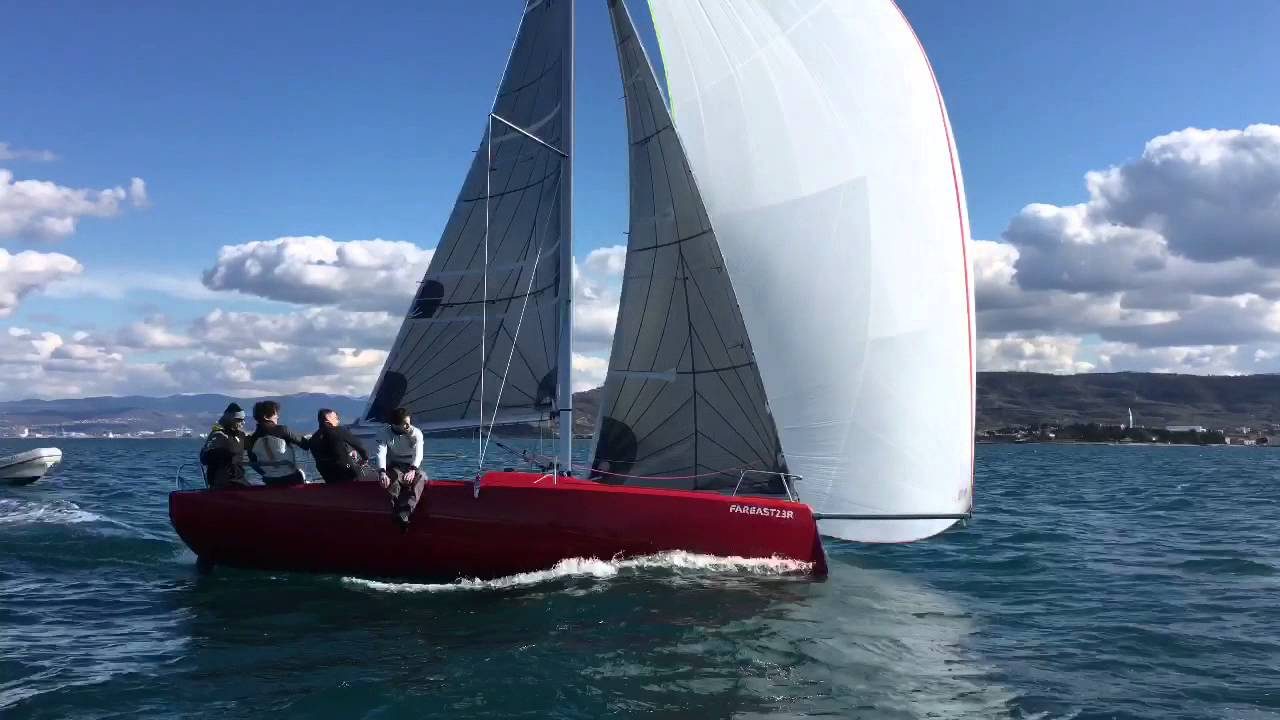 Red Fareast 23R sailing under a white spinnaker