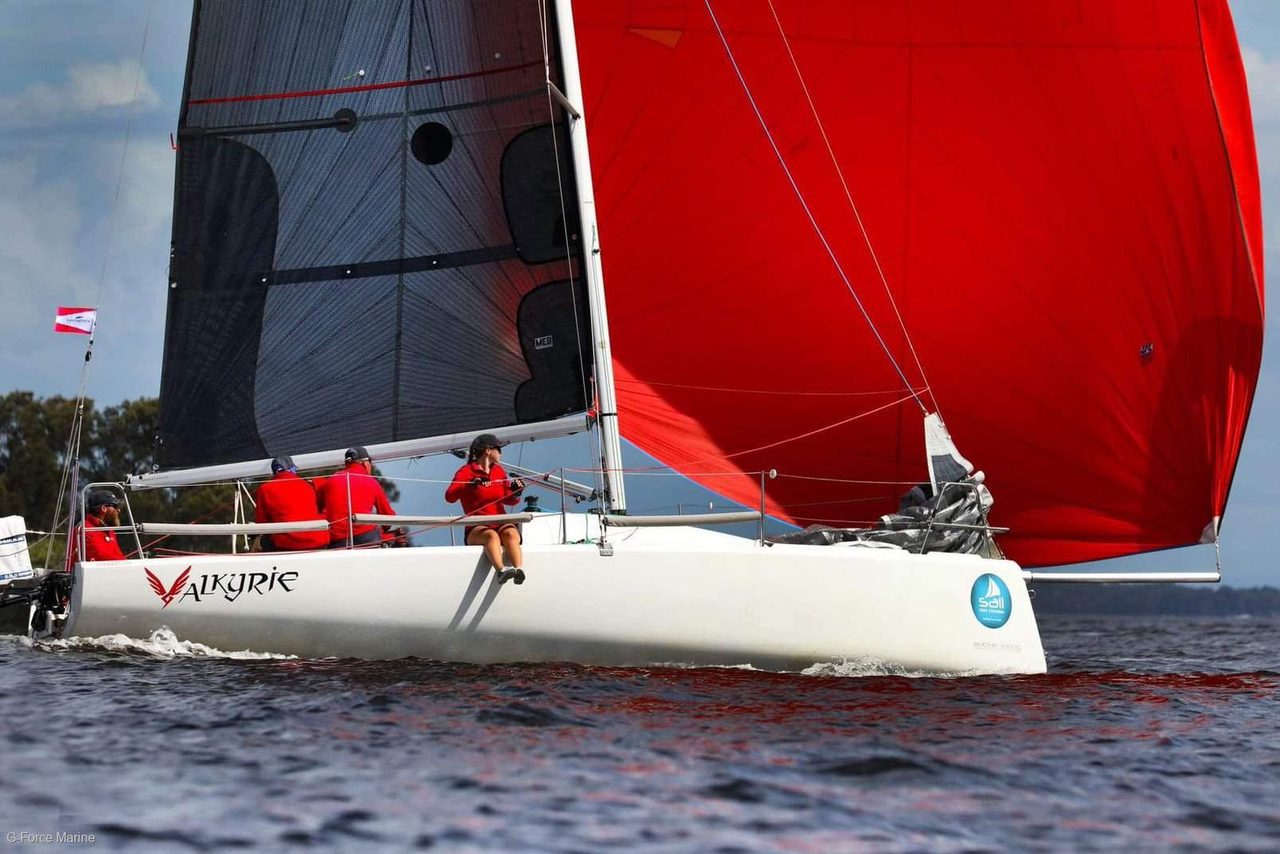 Fareast racing yacht under red and black sails