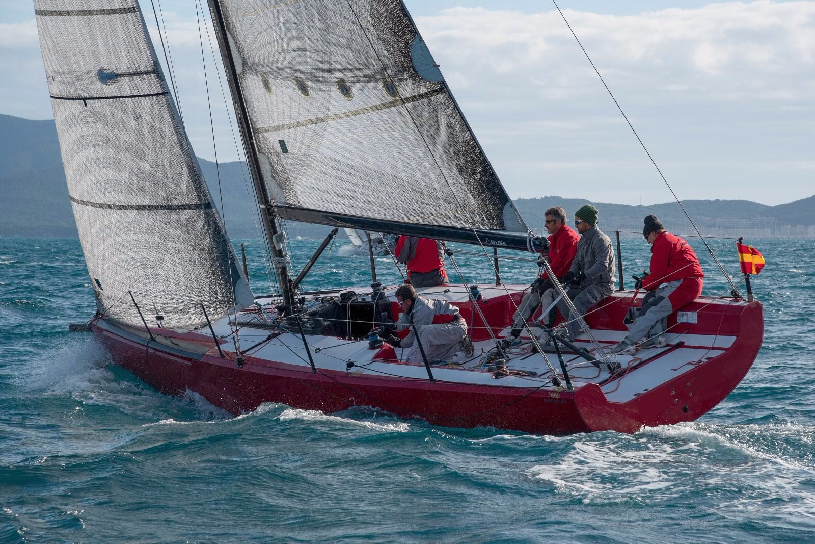 Red Fareast 31R racing in fresh conditions with a full crew