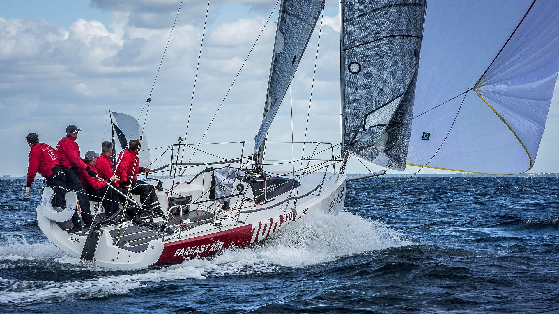 Fareast 28R racing yacht sailing under a red spinnaker
