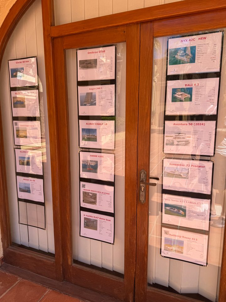 Yacht listings displayed in the office windows
